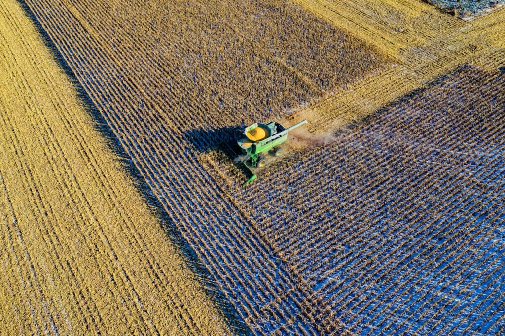 Aerial Photo Of Milling Truck On Field Harvesting Crops